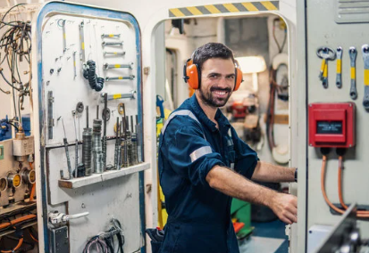 Technician performing acoustic emission testing on a large industrial tank